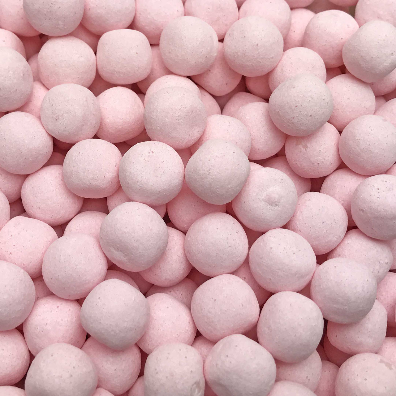 Close up of chewy strawberry bites – round pink Swedish candy with strawberry flavour