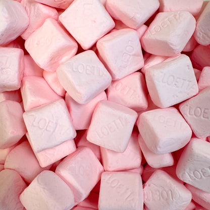 Close up of strawberry Sockerbitar marshmallows – pink chewy Swedish candy cubes