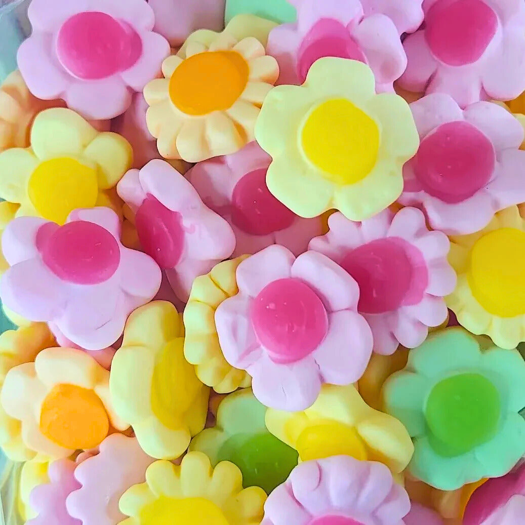 Colorful flower-shaped candies in various colors.